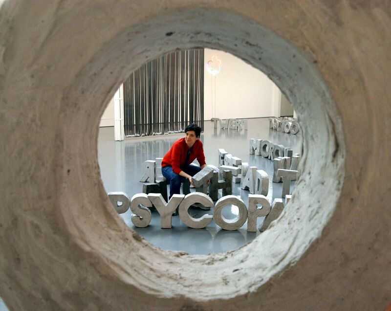 From Banner/Lislegaard's exhibition. Fiona Banner sits with her large letters which she has made out of clay.