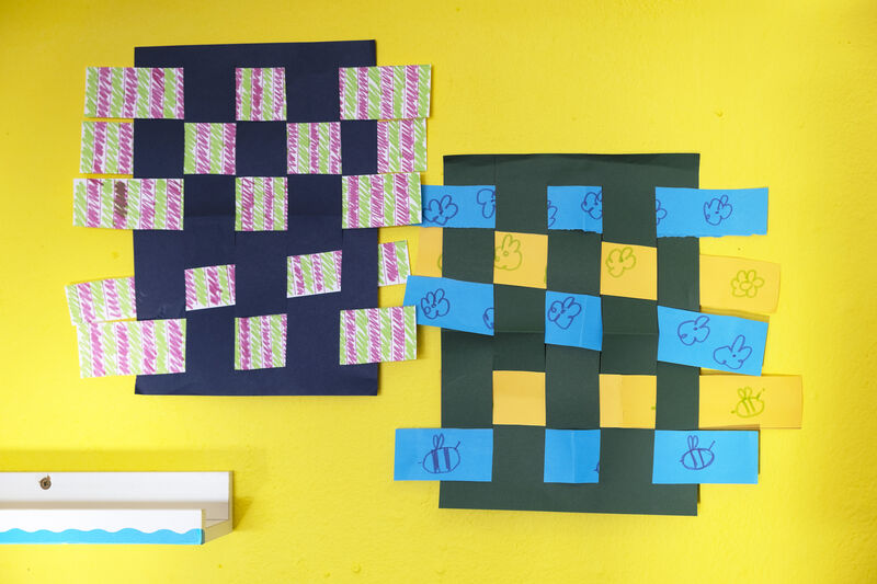Two woven paper artworks on the wall in Create Space