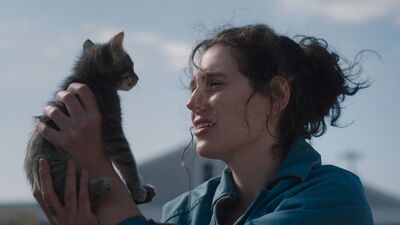 Woman with dark hair holds a kitten