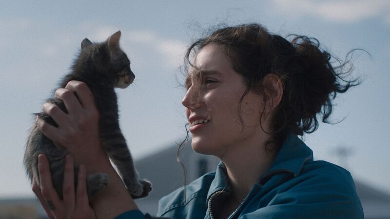 Woman with dark hair holds a kitten