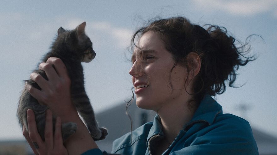 Woman with dark hair holds a kitten