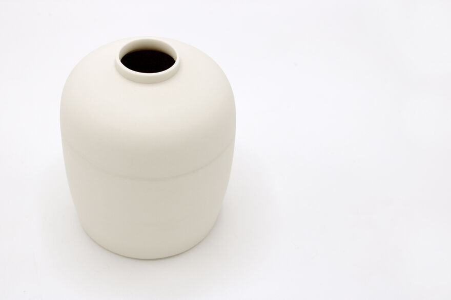 White porcelain vase on white background