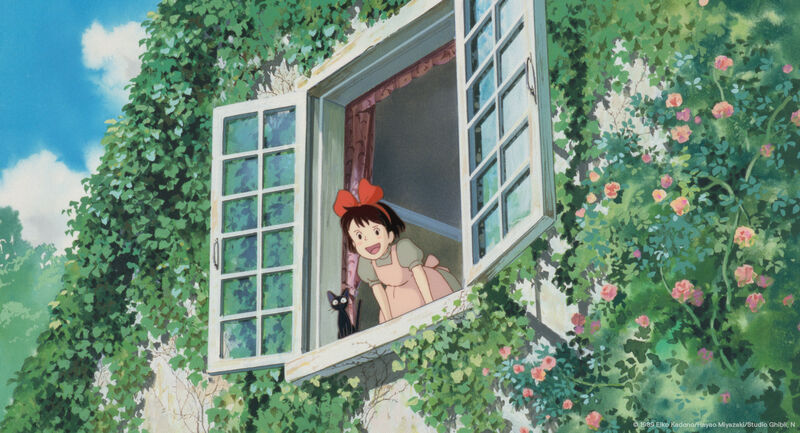 A cat and a young girl look out of a window