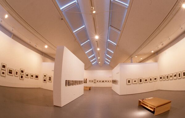 Small frames containing black-and-white photographs hang in DCA Galleries.