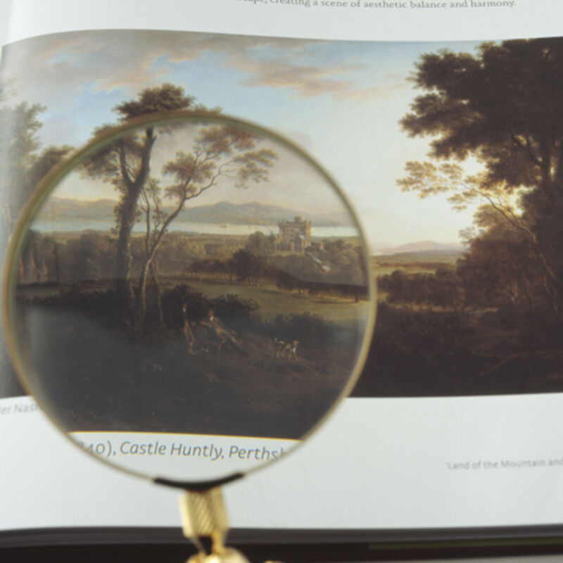 From Matts Leiderstam's exhibition in DCA Galleries. A magnifying glass is held up to a 19th century landscape painting.