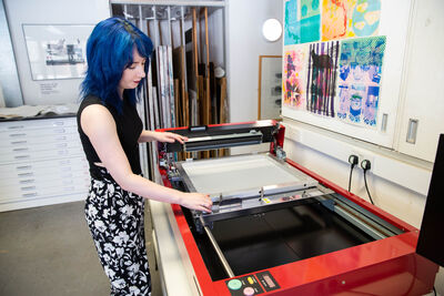 Person using the GoccoPro machine to transfer and image onto screen printing mesh