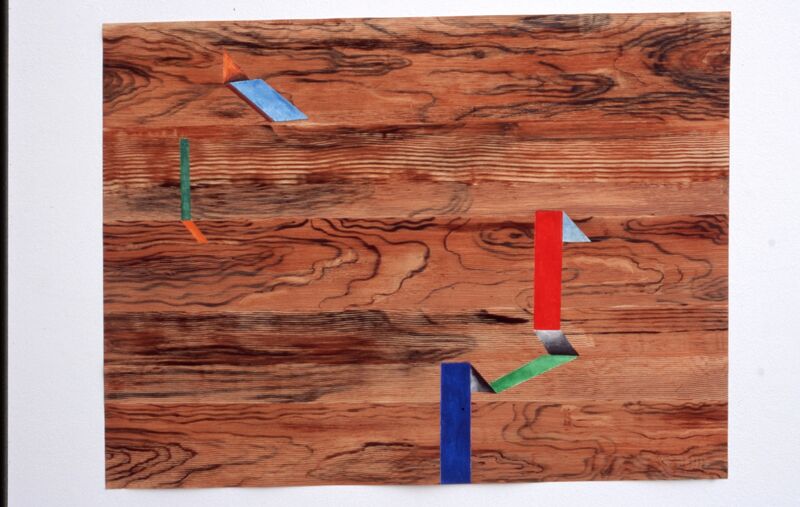 A wooden board with colourful rectangular shapes painted on it.