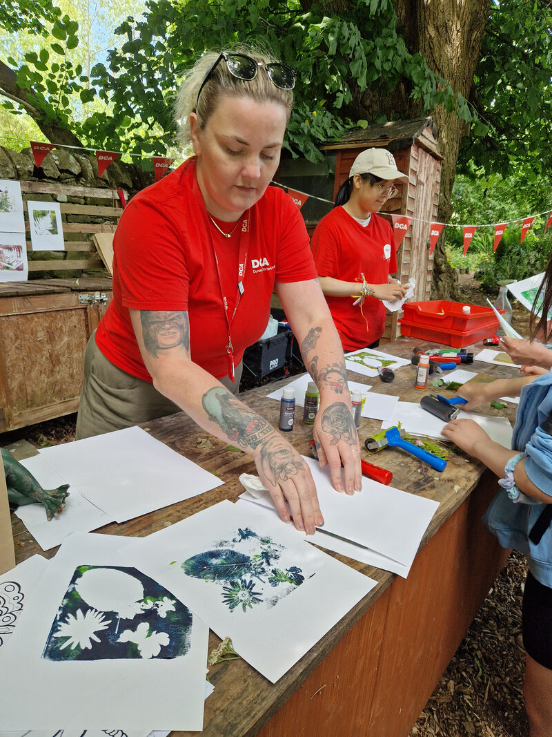 DCA Staff showing children how to make gelli prints