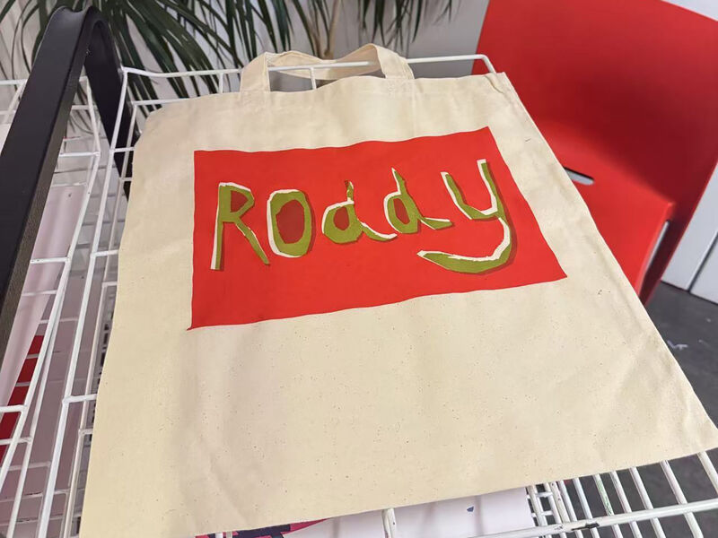 Tote bag with red rectangle with the name Roddy printed in green ink