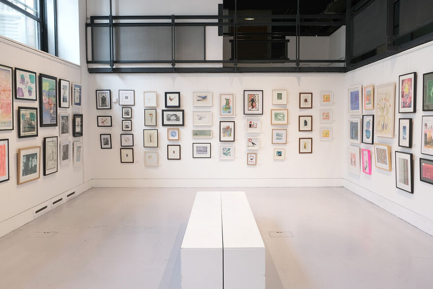 Centrespace 1 with framed prints on the wall and benches in the middle of the room