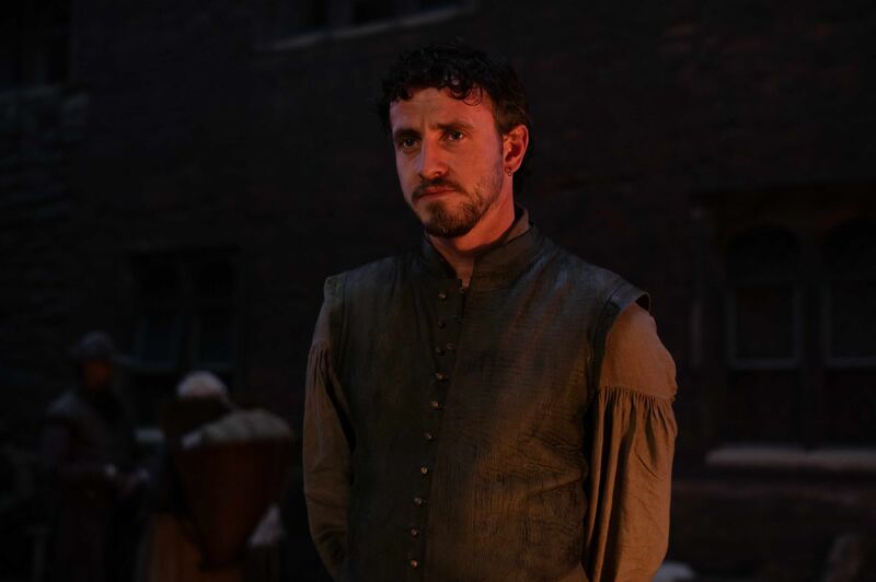 Paul Mescal wears medieval clothing in a dark room