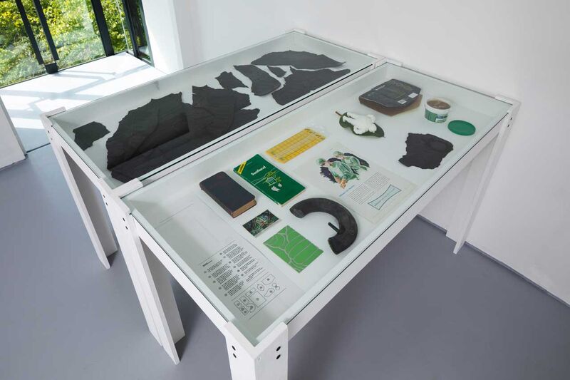 A glass topped table with small details of tyres and Michelin memorabilia 