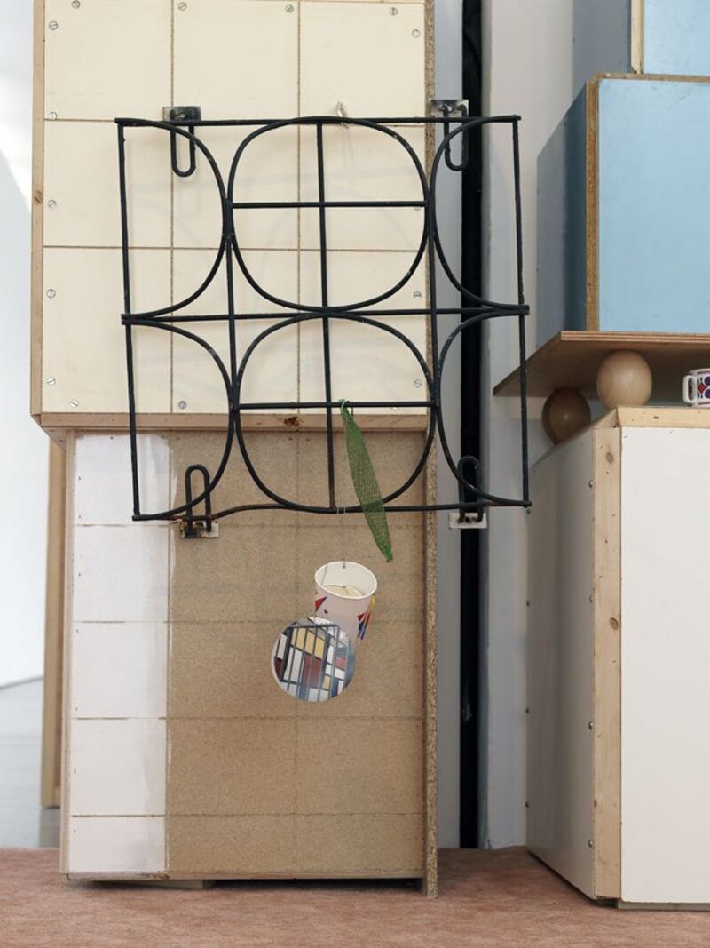 From Manfred Pernice's exhibition. A black wire rack leans against the wall.