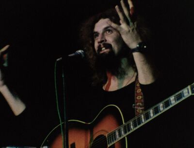 Billy Connolly playing guitar in the 1970s
