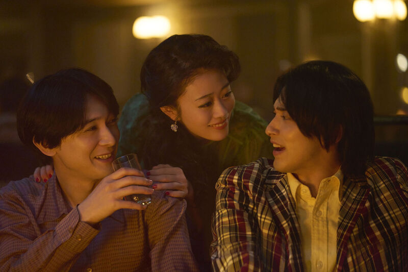 Two Japanese men and a woman laugh