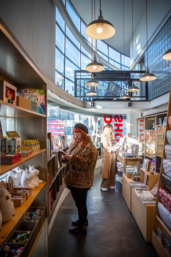 Two customers browse in DCA Shop.