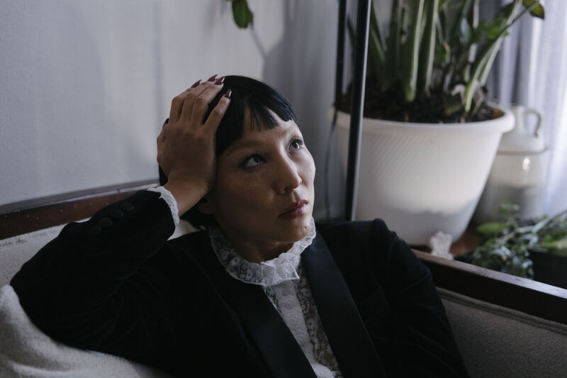 A woman sitting down looks up