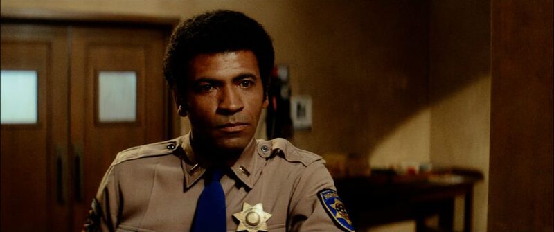 Black police officer in a room