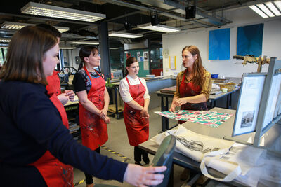 Group of people being shown round DCA Print Studio