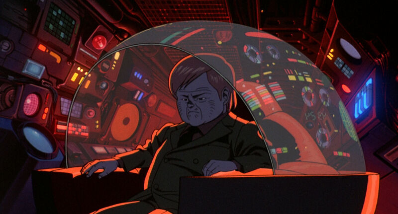 Still from anime AKira showing a man sitting in a control room surrounded by lights and buttons