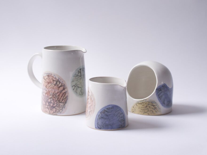 Two ceramic jugs, one smaller and one with a handle, and a ceramic sponge holder