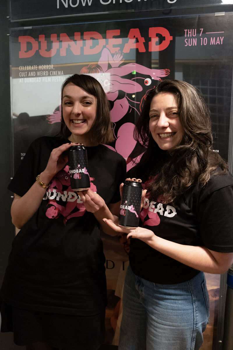 Rachel and Camilla of Invisible Women holding cans of Dudnead IPA and wearing Dundead t-shirts