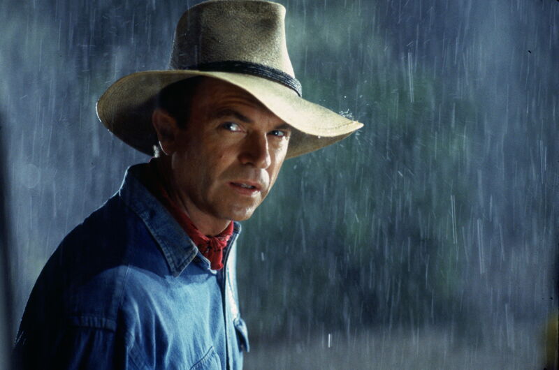 Sam Neill stands in the rain in Jurassic Park