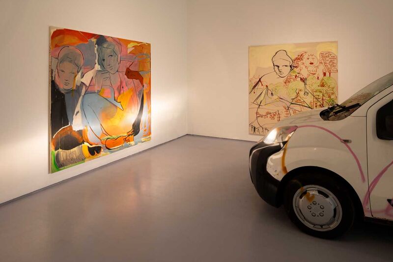 In a gallery space: a van illuminates a large colourful painting 