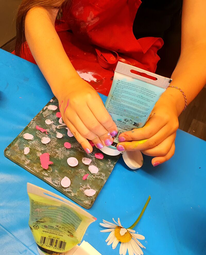 Person adding paint dots to a gelli screen
