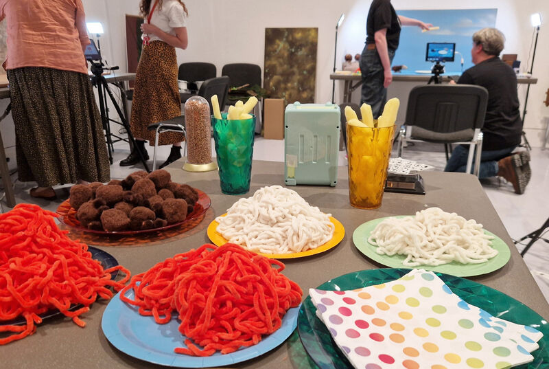 People doing stop motion animation with pretend food stuff