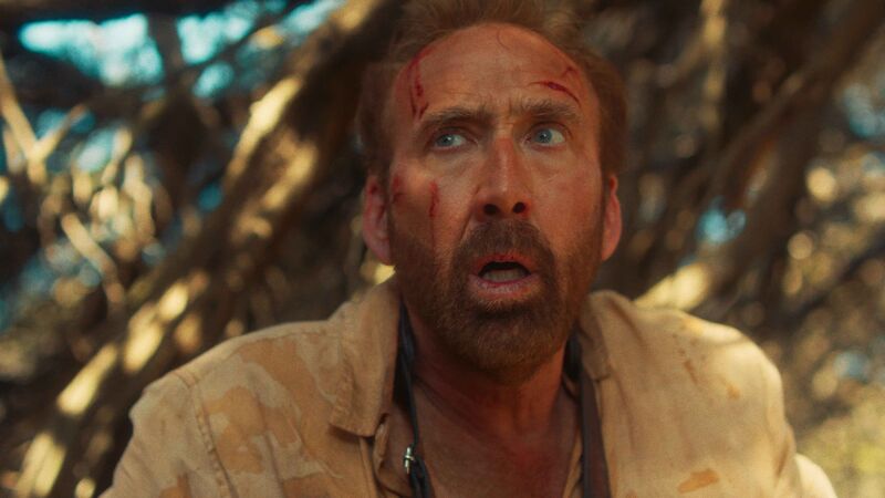 A man with blood on his face looks up in panic.