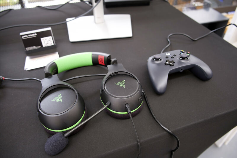 Headphones and a controller sit on a desk