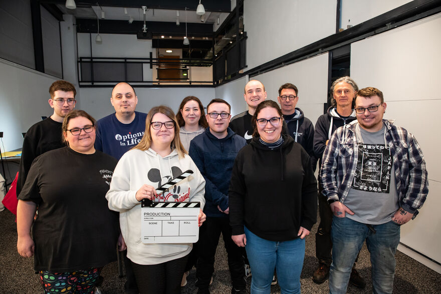 Options in Life group with one member holding a clapper board