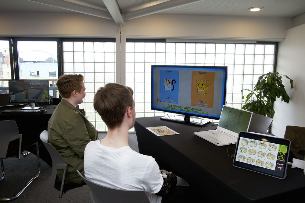 Two people enjoy playing a game together at Drop in and Play