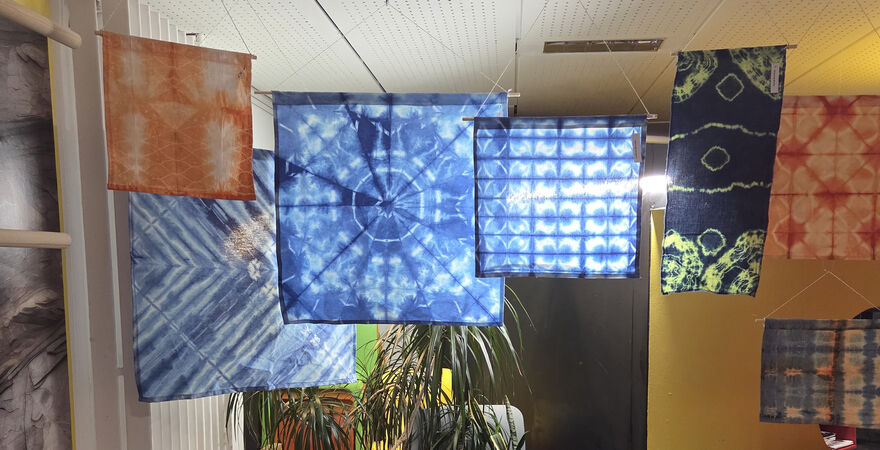 Printed Shibori fabrics hanging up in Create Space