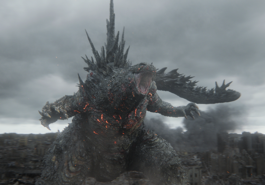 Godzilla rears up from a ruined city roaring