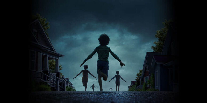 Children run down a dark street with their arms stretched out