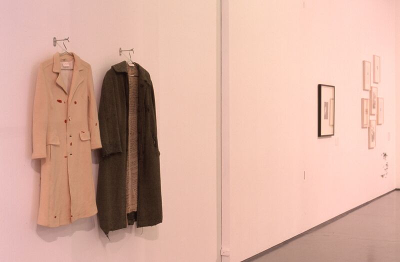 Two coats hang from DCA Gallery walls.