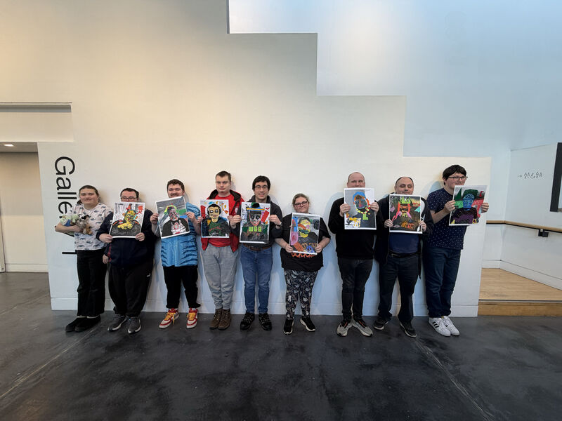Group of people holding decorated portraits