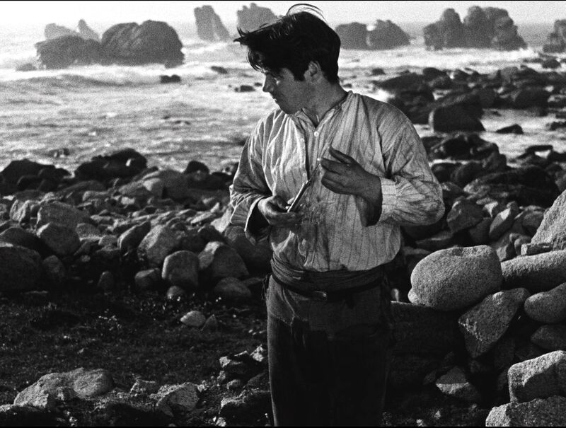 Young man on a beach in vintage clothing