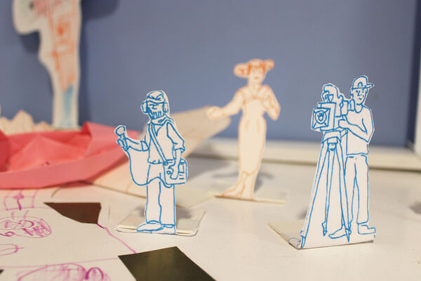 Small cut out figures of a sound person, camera person and actor