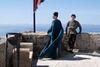 A young man and older woman in historical costume on a Greek rooftop in The Odyssey