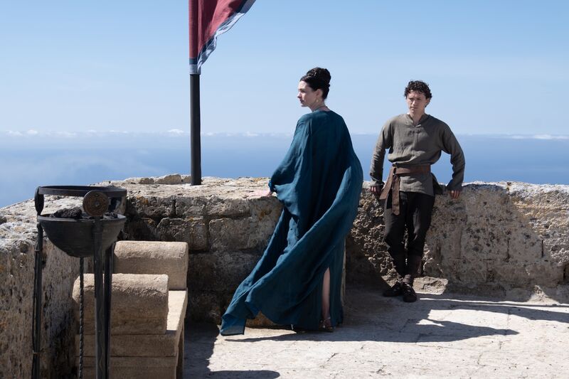 A young man and older woman in historical costume on a Greek rooftop in The Odyssey