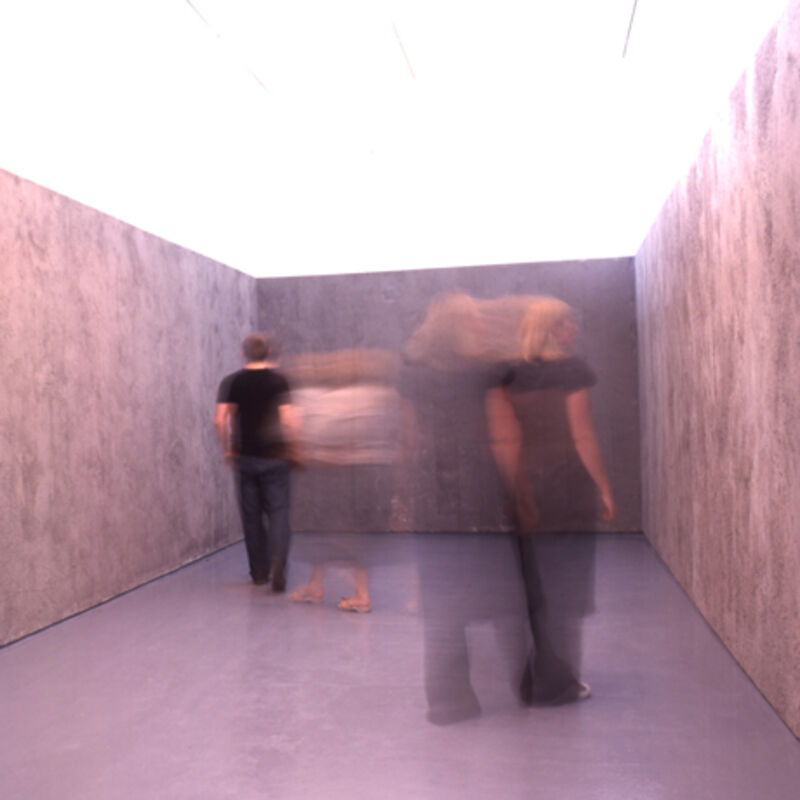 From Miroslaw Balka's exhibition at DCA. Three motion-blurred people walk through a grey room.