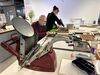 ST/ART member and tutor in DCA Print Studio at a table of letterpress equipment
