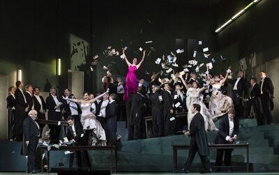An opera with singers surrounded by falling money