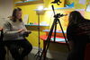Two people working on an animation using a tripod and a remote