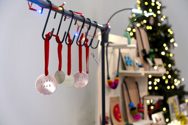 Decorations hanging up at Crafted 2024 with Christmas tree in the background
