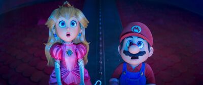 A still from the animated film The Super Mario Galaxy Movie shows Princess Peach and Mario looking surprised.