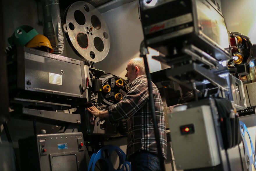 A projectionist using a projector